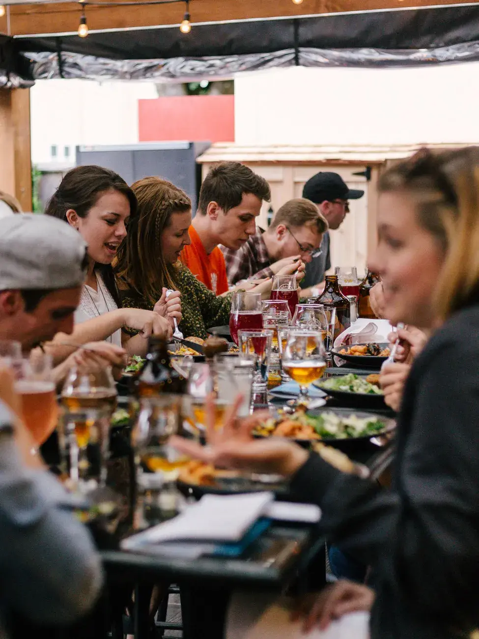 Friends sharing beer and food around a table
